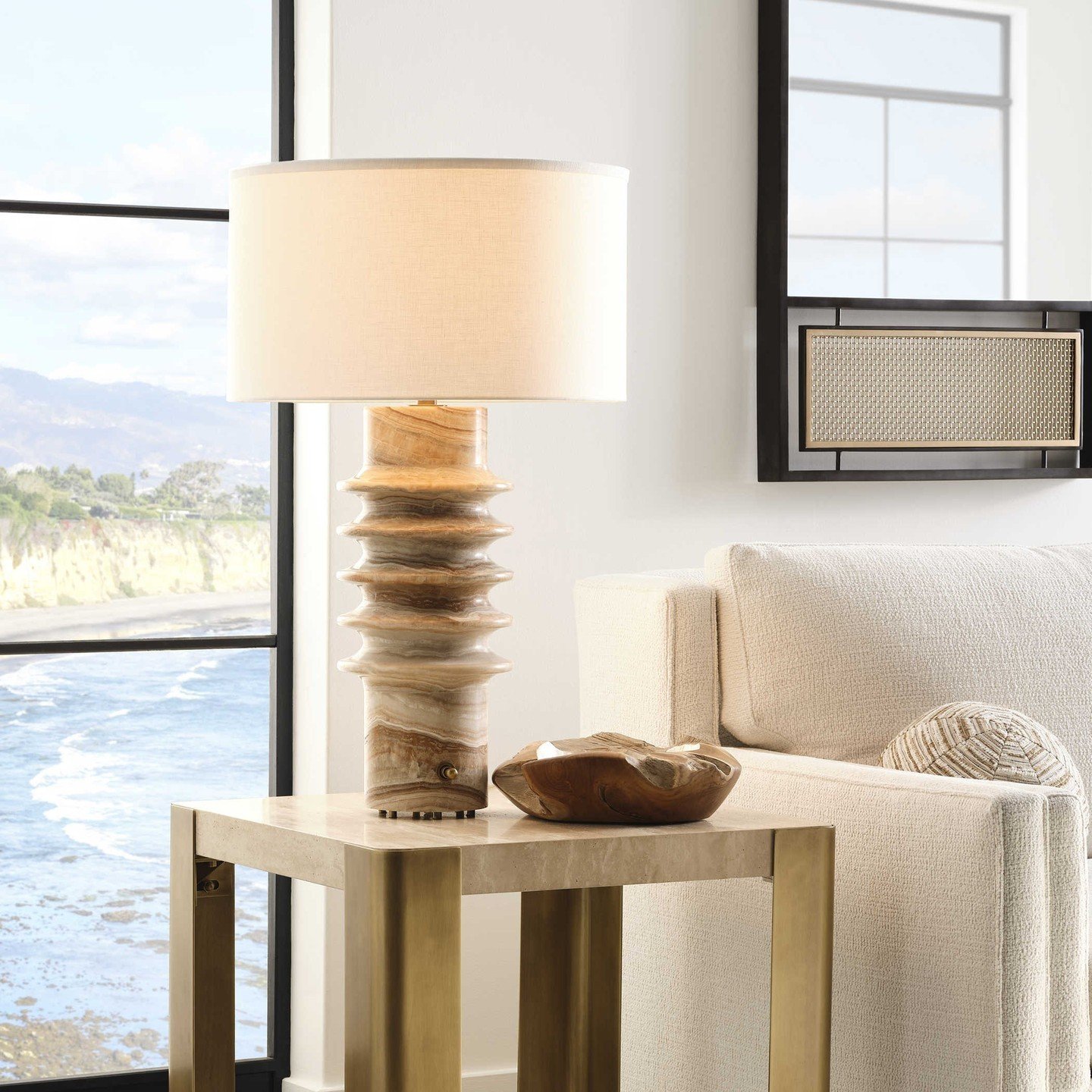 Statement lighting doesn't have to hang from the ceiling! This luxurious gold, gray and cream onyx, lamp has a tailored shade with an integrated diffuser on top. The single socket light has a rotary dimmer in the base that adjusts light to provide ge