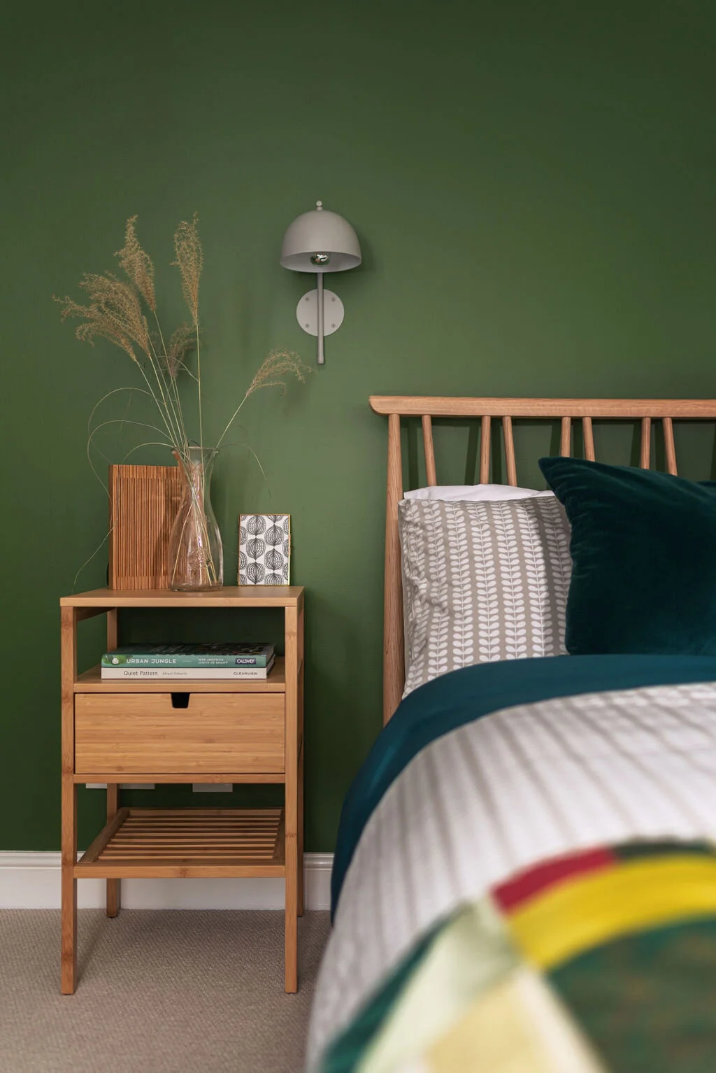 Warm grey walls pick out the warmer tones in the wallpaper whilst working well with dark wood furniture and this contemporary metal side table