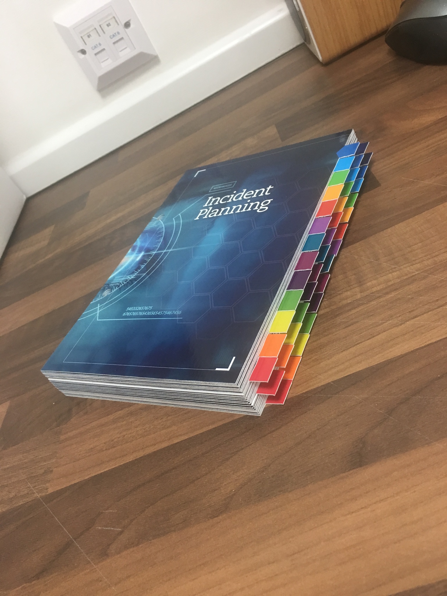 Digitally printed incident planning notepad on the front cover with multiple page markers on the side