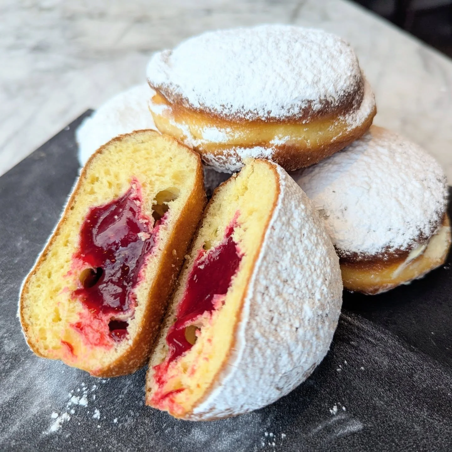 We're in the midst of pączki season AND buttercream donut season!

Everyday we'll have two different flavors of pączki. Today is apricot and raspberry. Both fillings are made in house from actual fruit and the dough is a traditional pączki dough made