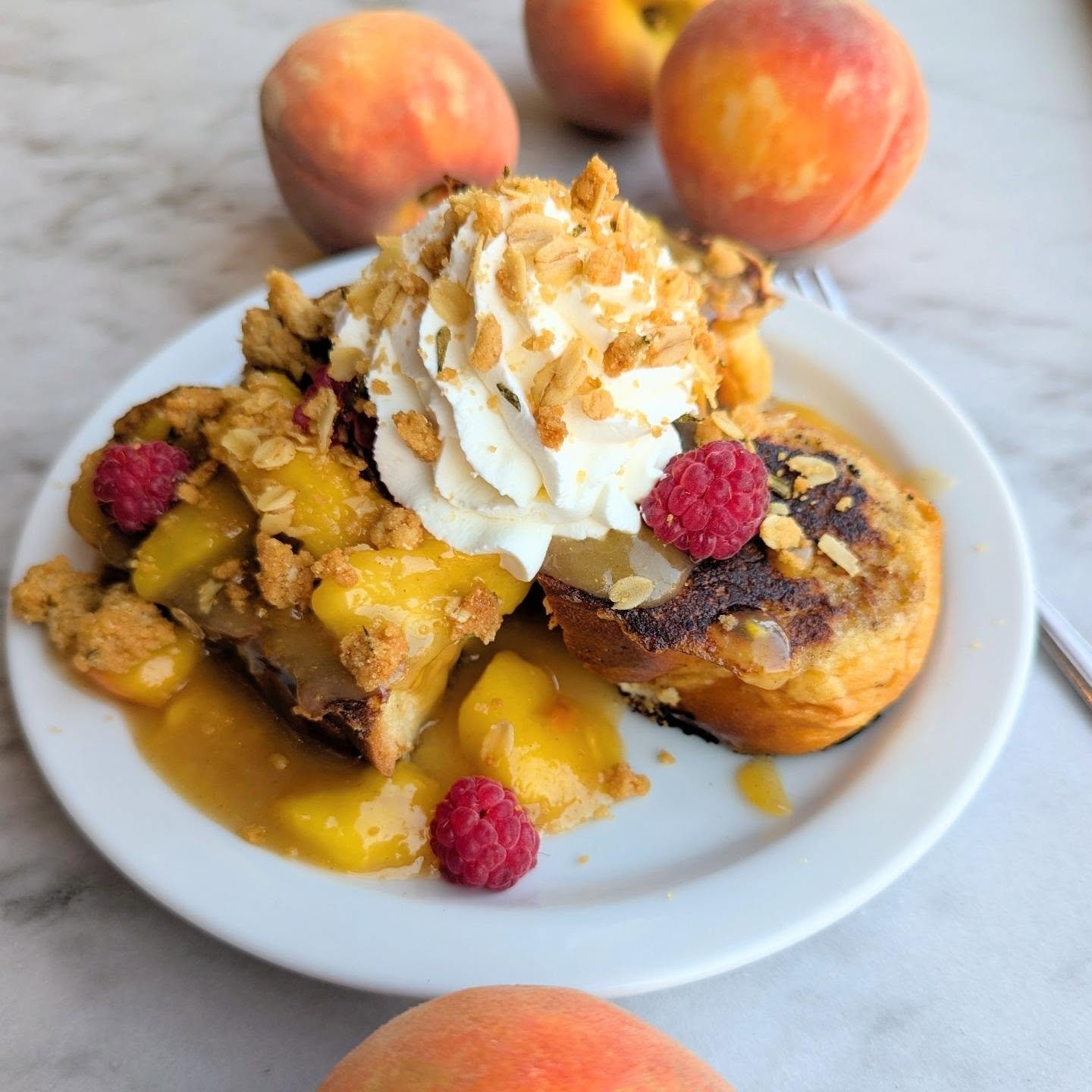 Sunday at the bakery means brunch!

We got away from ourselves with today's specials. French toast is topped with Fruit Haven Orchard (thanks Bob!) peaches and raspberries, then finished off with whipped cream and a rosemary oat crumble.

We're also 