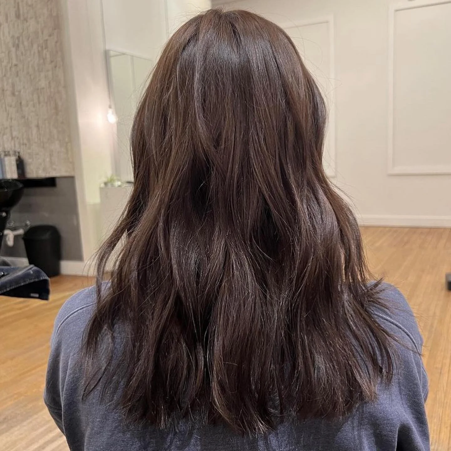 Long brunette hair result from the back, salon setting