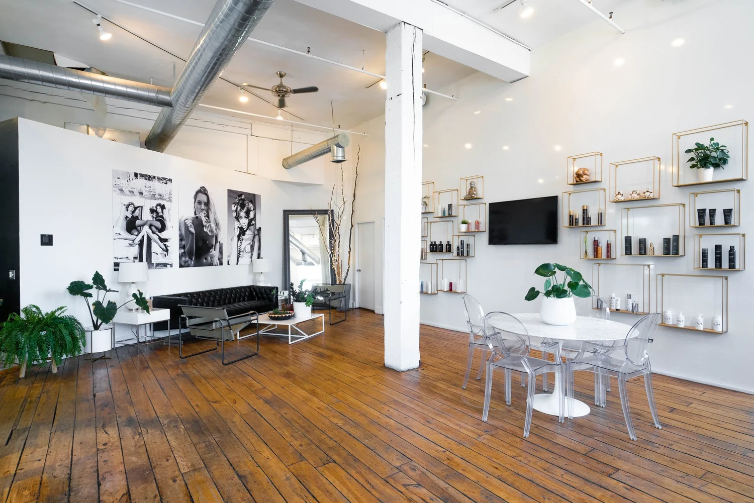 Open salon space with product shelves and dining table