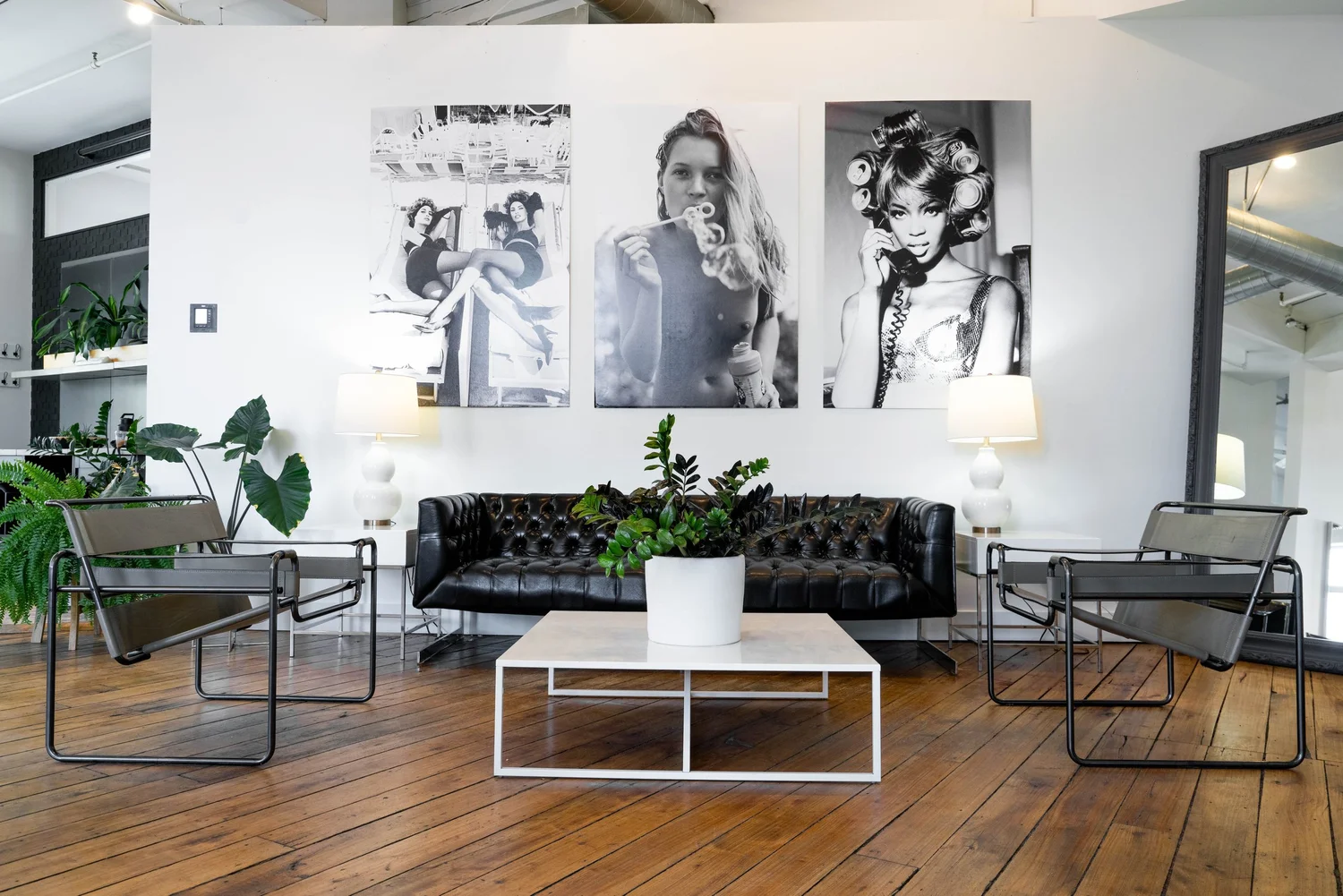 Lounge with black sofa and framed black-and-white photos