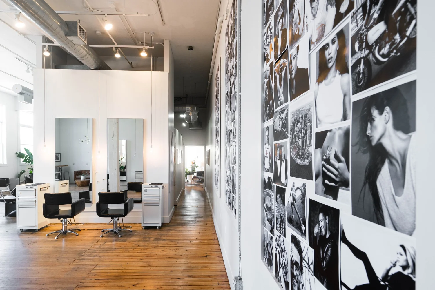 Styling stations beside wall of black-and-white photos