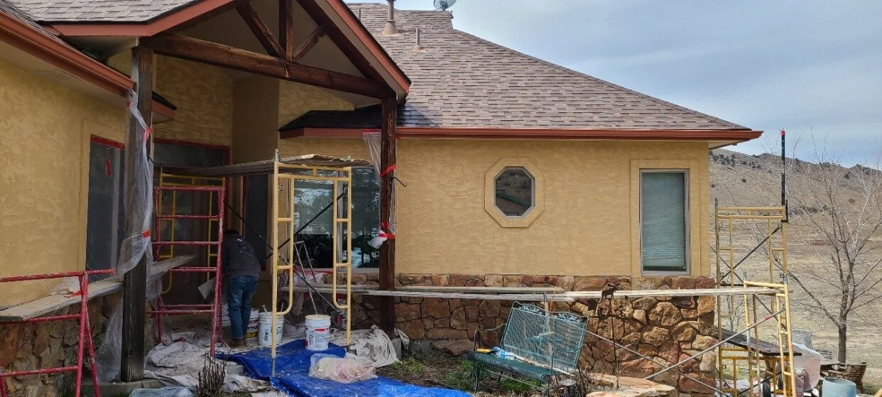House under construction with scaffolding and plastic sheeting