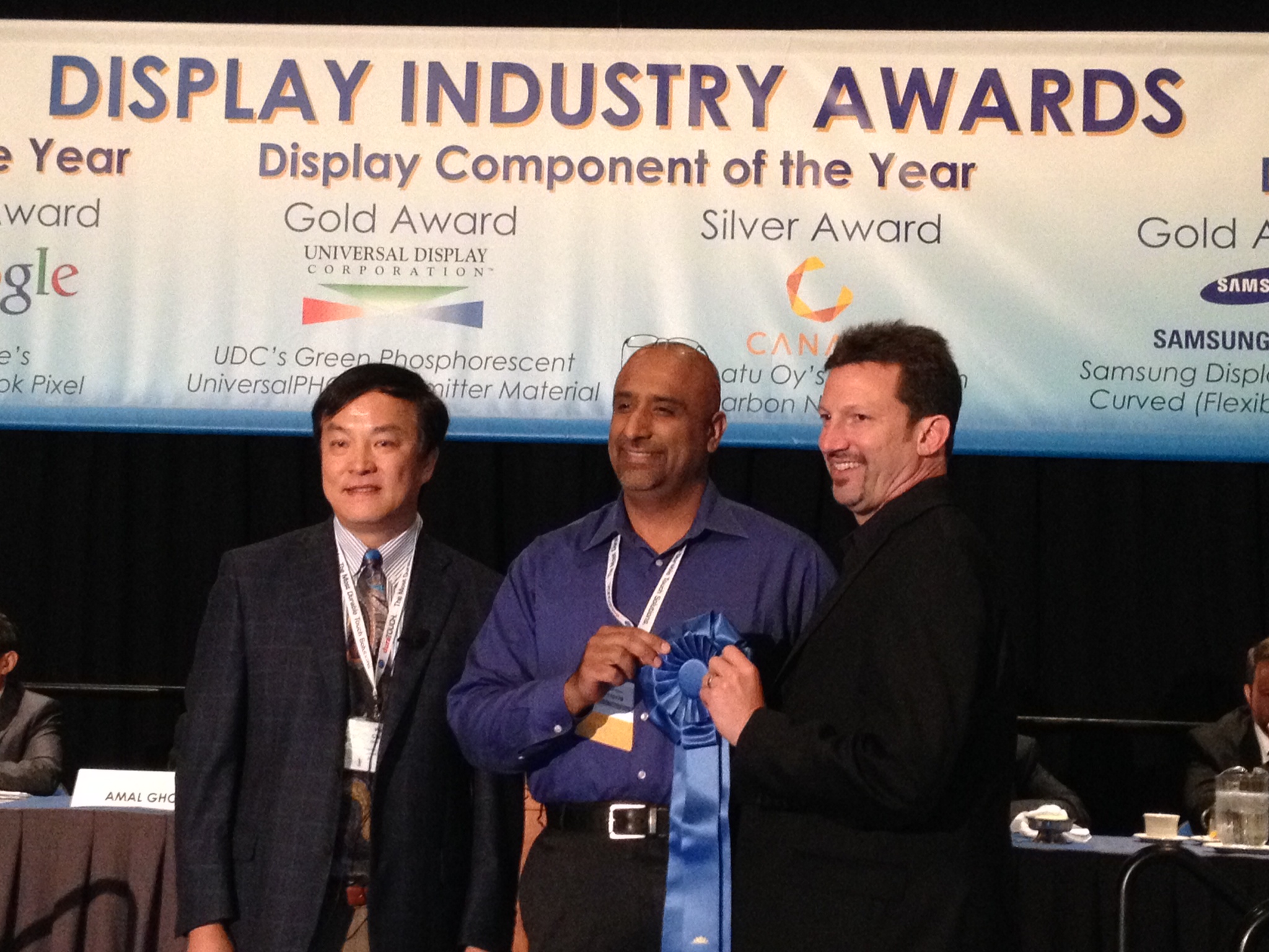 Nanosys CEO Jason Hartlove (right) and Dolby's Ajit Ninan (center) accepting the Best in Show award from Apple's Wei Chen at the 2014 Display Industry Awards in San Diego
