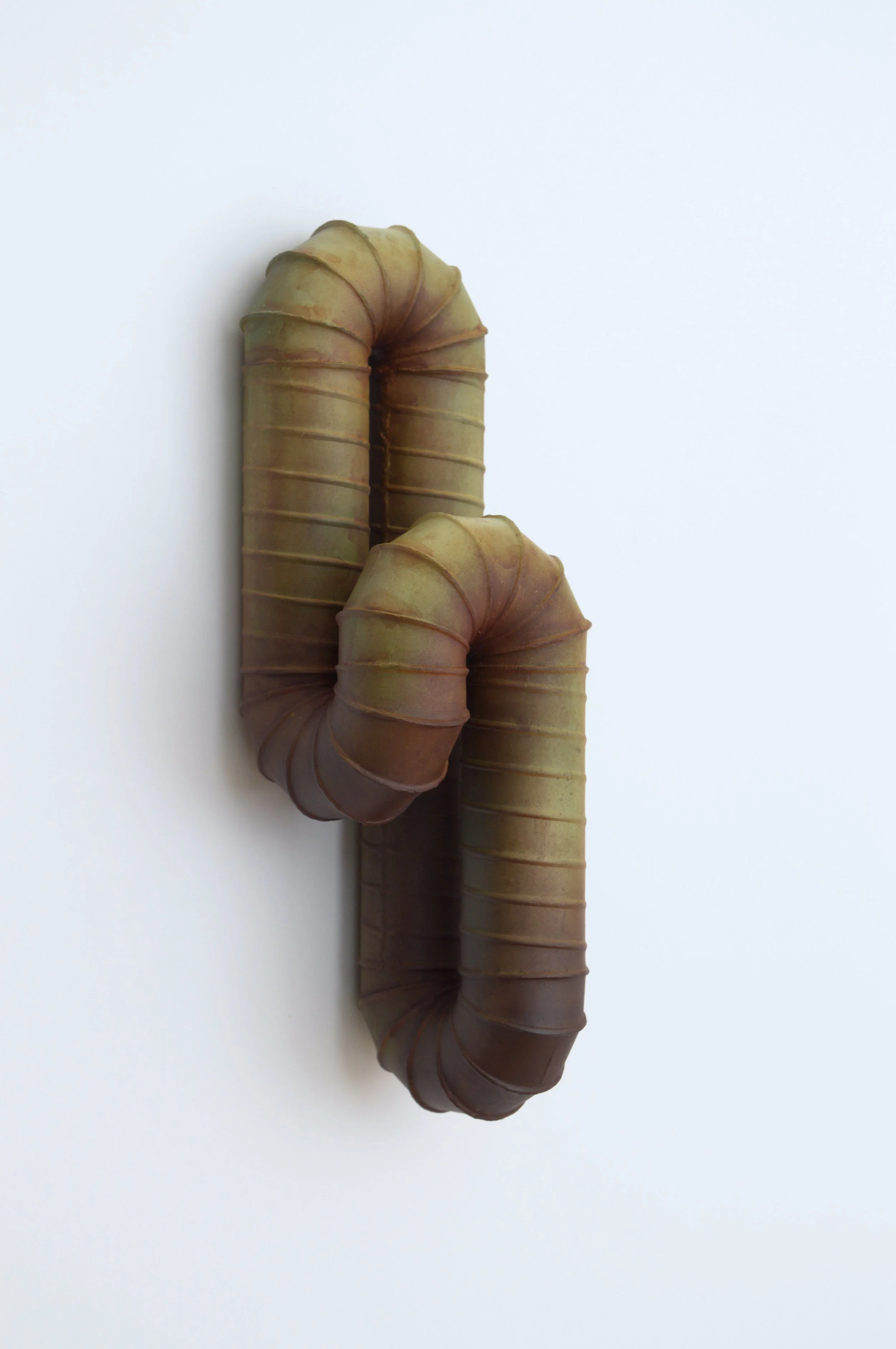 Frans Lotz, “Slump”, painted steel with rust, 2025, 4 x 12 x 4 inches.