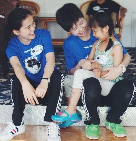 Making friends at camp. These volunteers traveled from southern China to help!