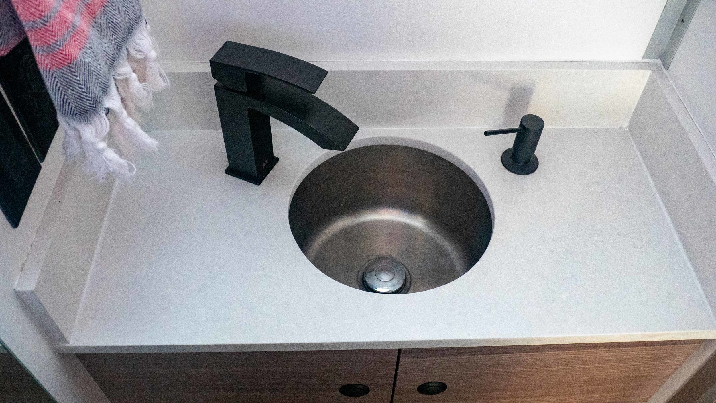 wash room sink with quartz countertop, outlets, USB ports