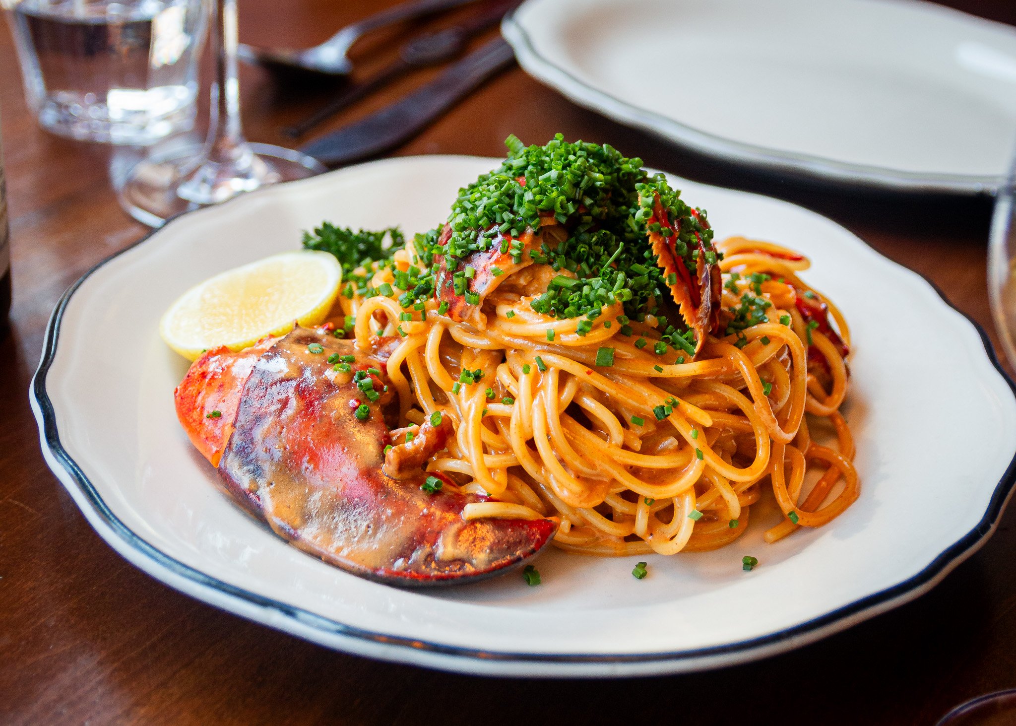 Alexandria's favorite lobster pasta featuring succulent tail meat and fresh chives.