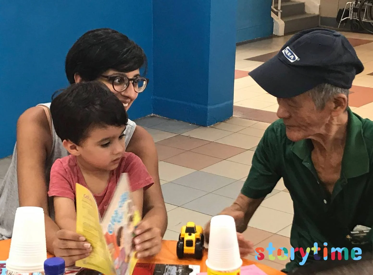 Volunteer reading to elderly.jpg