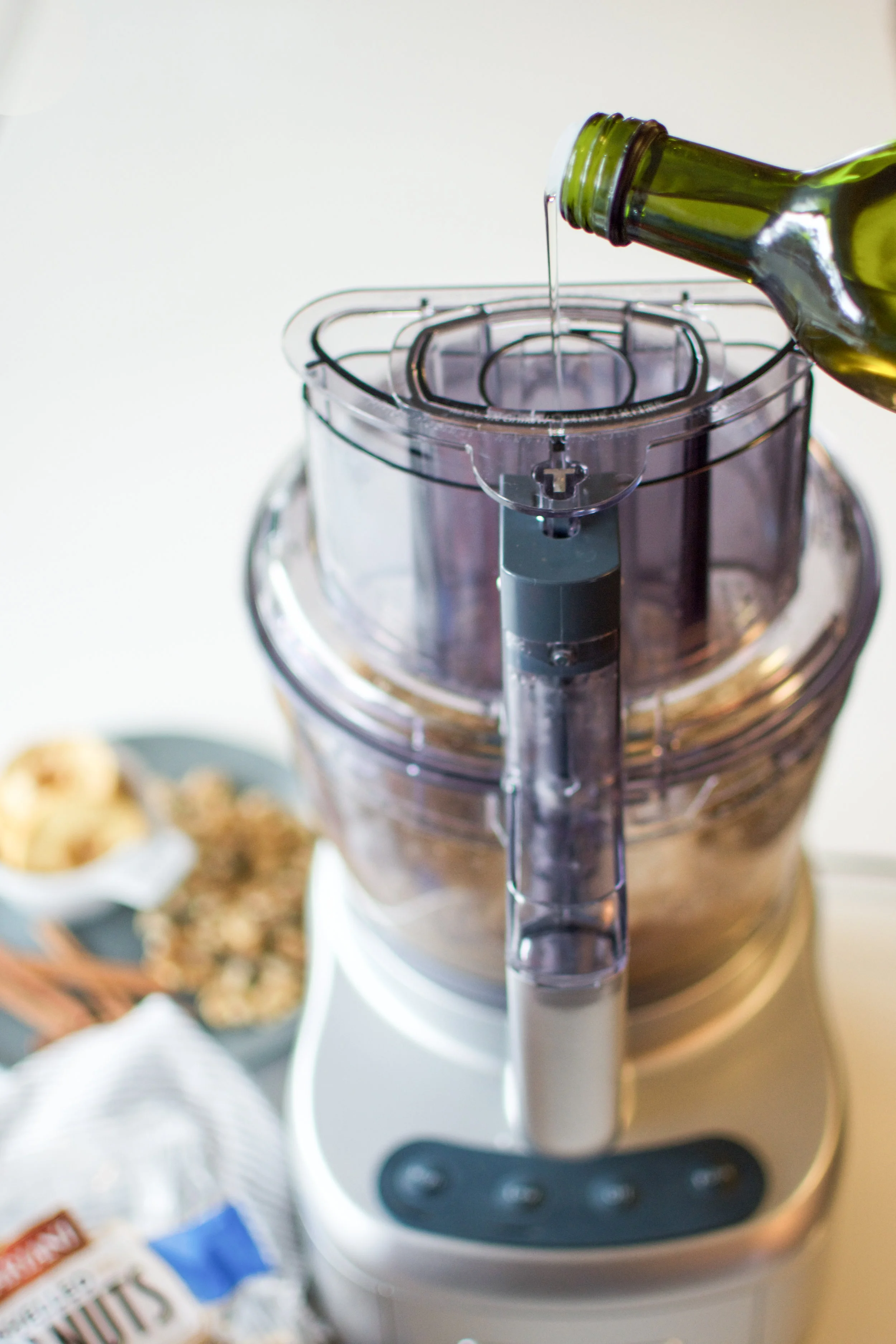 With the machine running on high, slowly drizzle ¼ cup of the avocado oil into the machine, which will loosen the butter and continue to process until smooth.