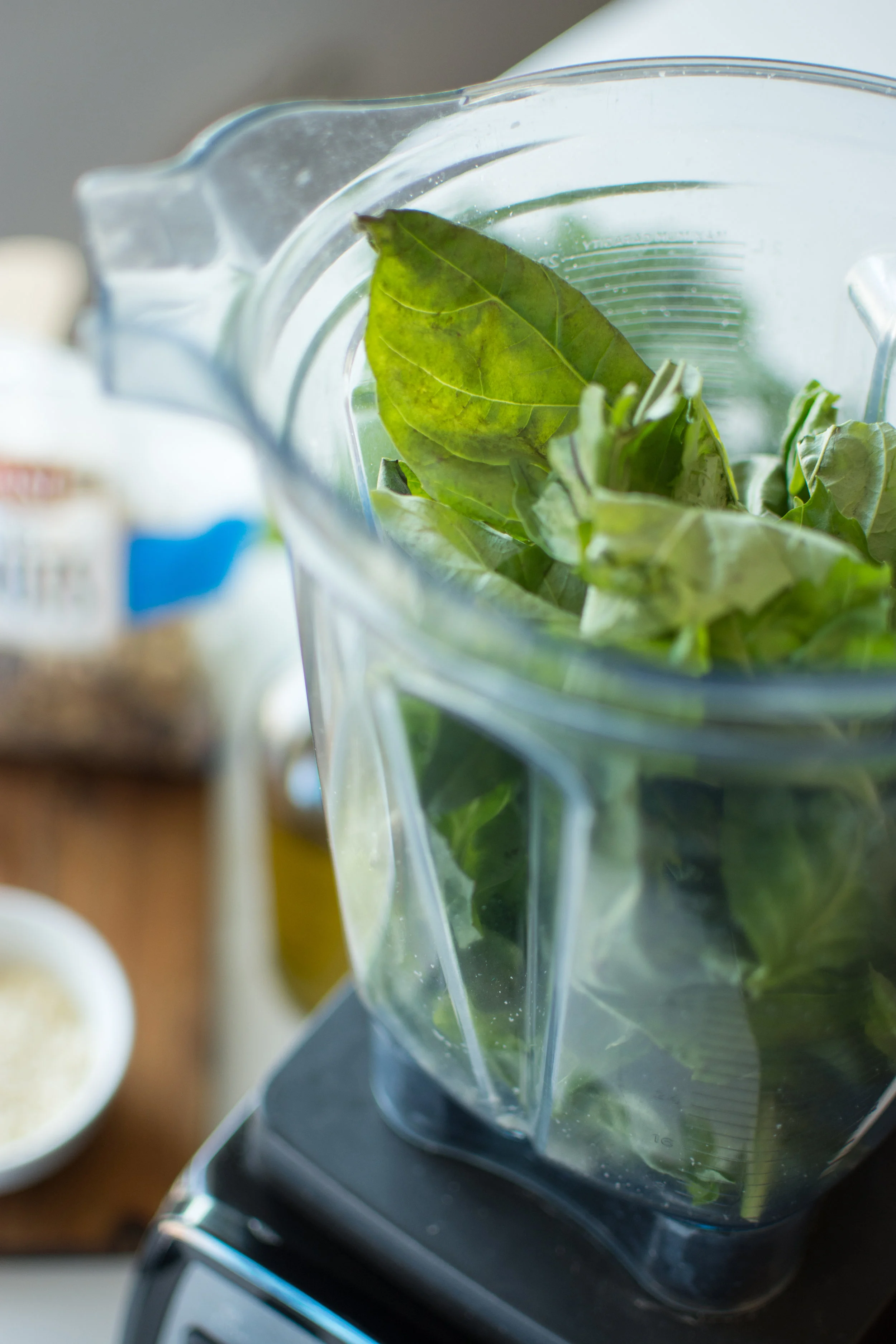 Once you are done with all your prep. Start by placing the fresh basil leaves in the processor of your choice.