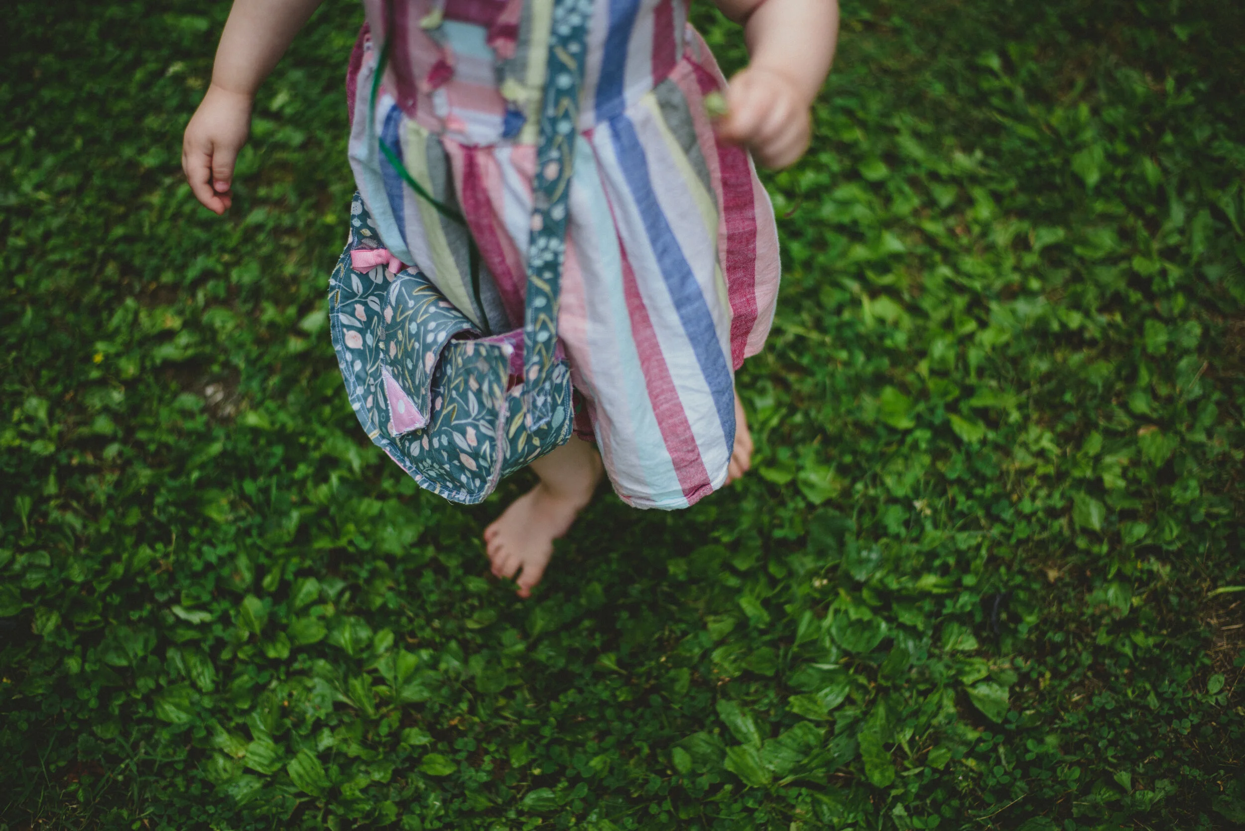 little girl barefoot in the grass