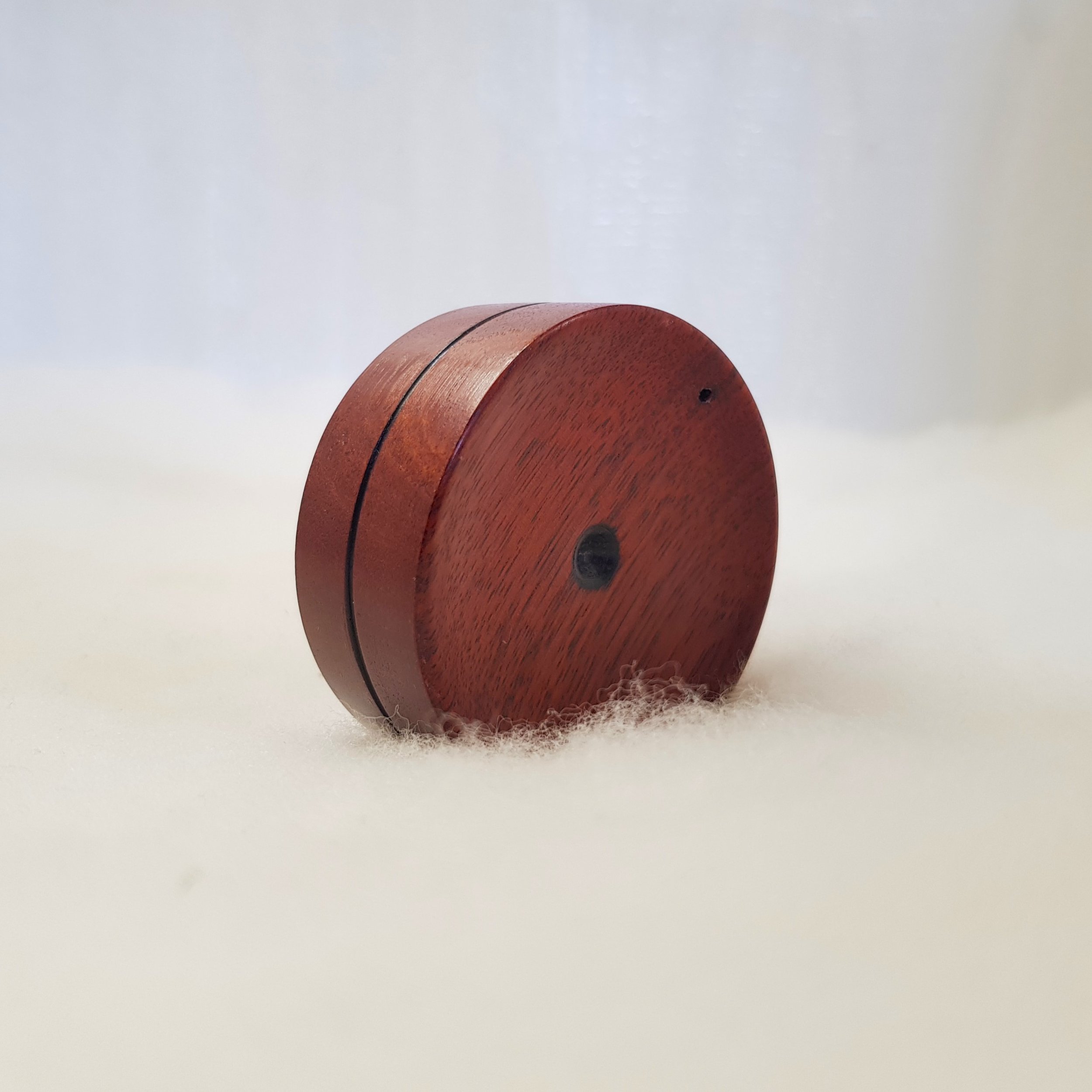 Reversible pocket spinning surface in Figured Jarrah and Frogwood Center.