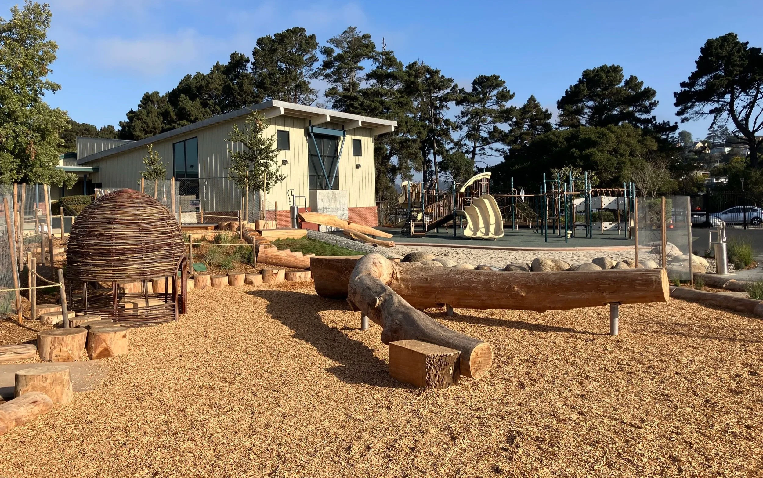 View of climbing logs and a branch hut on the new Nature Play playground at Prospect Sierra Middle School.