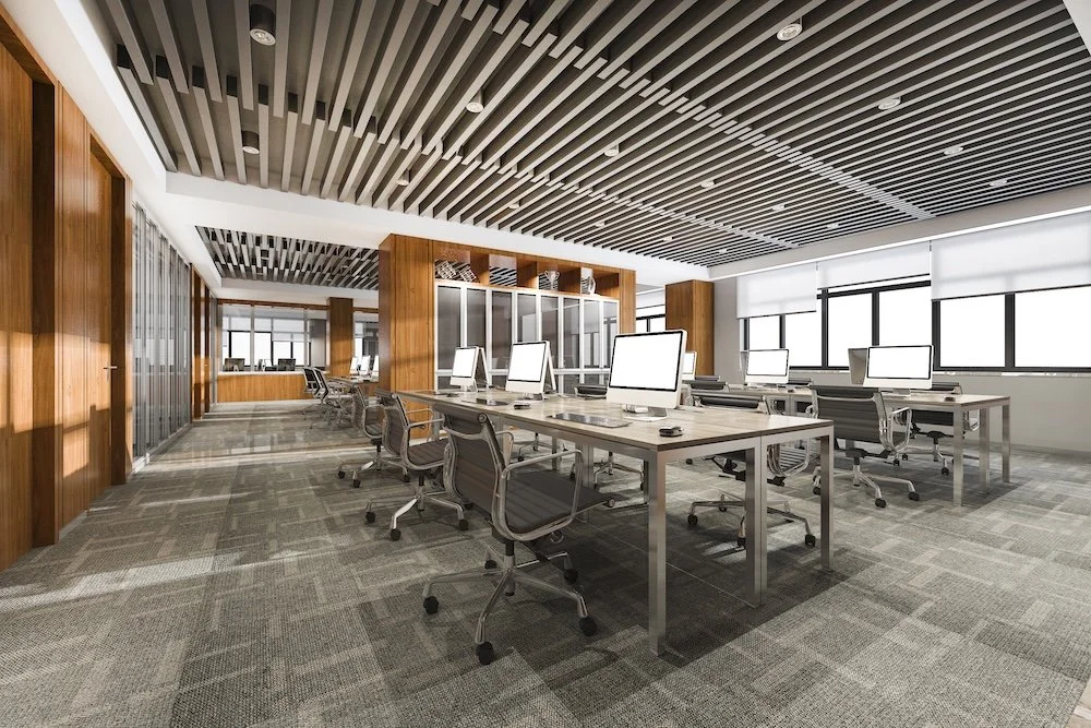 Modern office space for rent featuring open workstations, contemporary furnishings, and large windows providing natural light