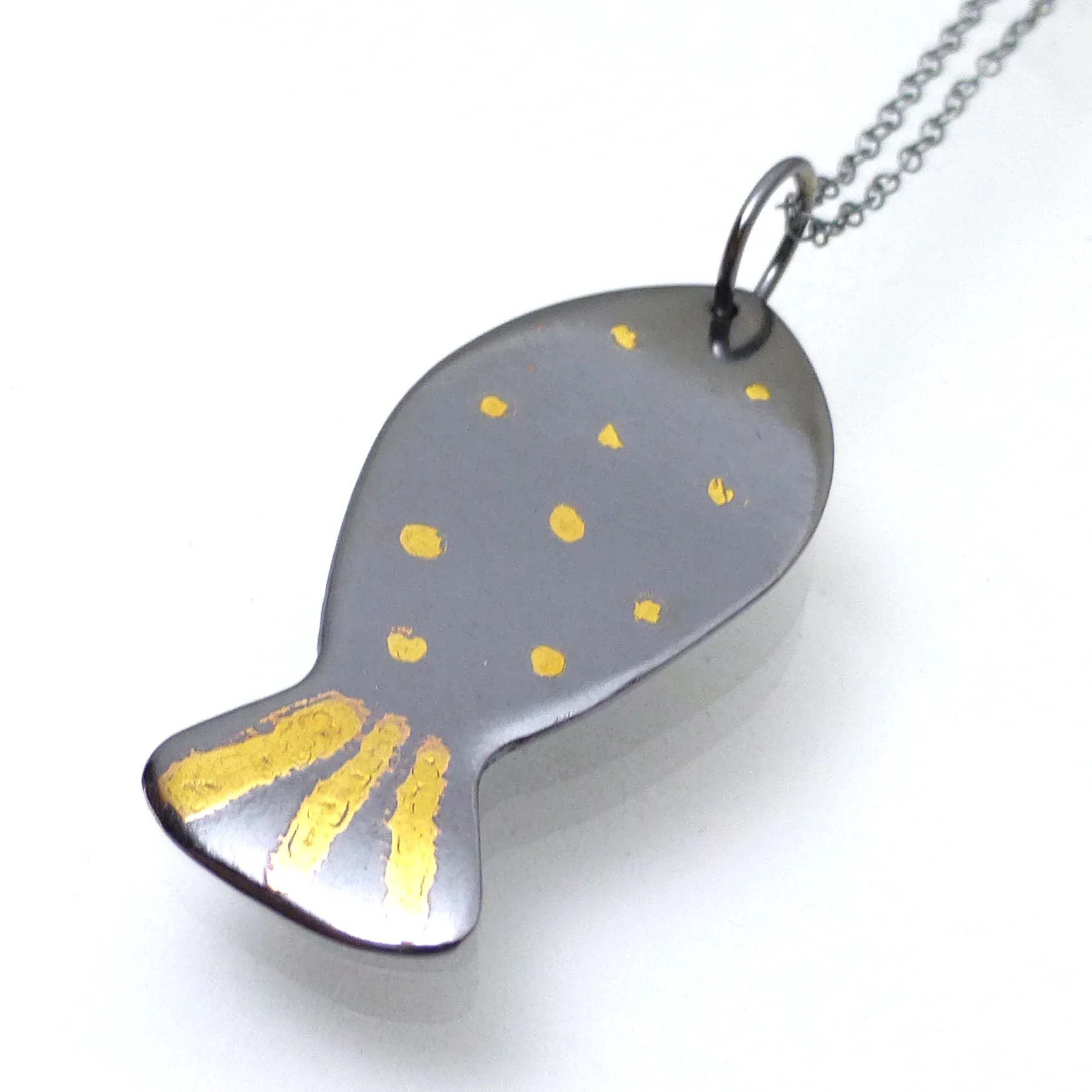 Fish necklace with 22kt gold dots