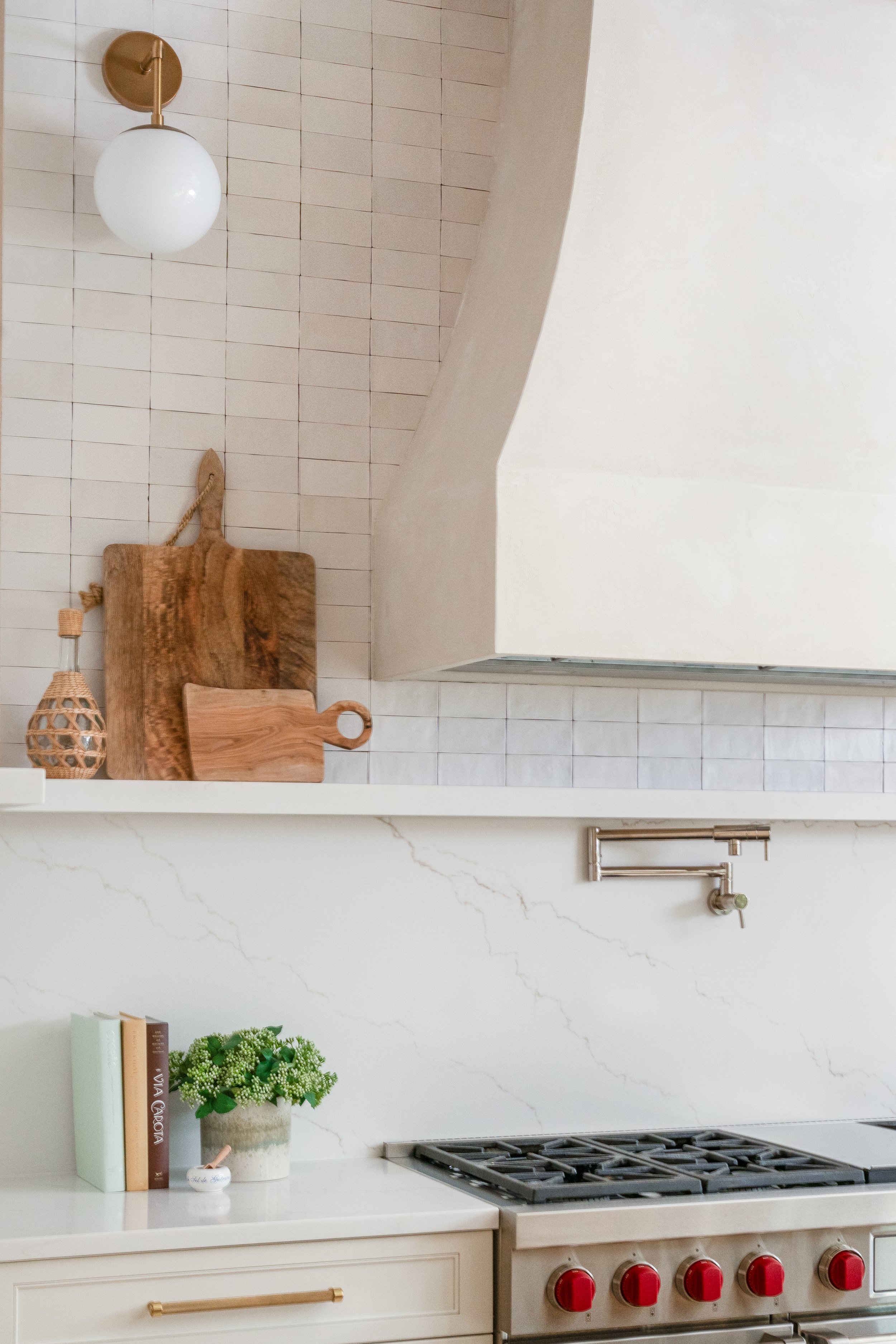 Oceanforest Residence_MicamyDesignStudio_High end kitchen design_hand finished range hood_quartz backsplash and ledge vignette.jpg