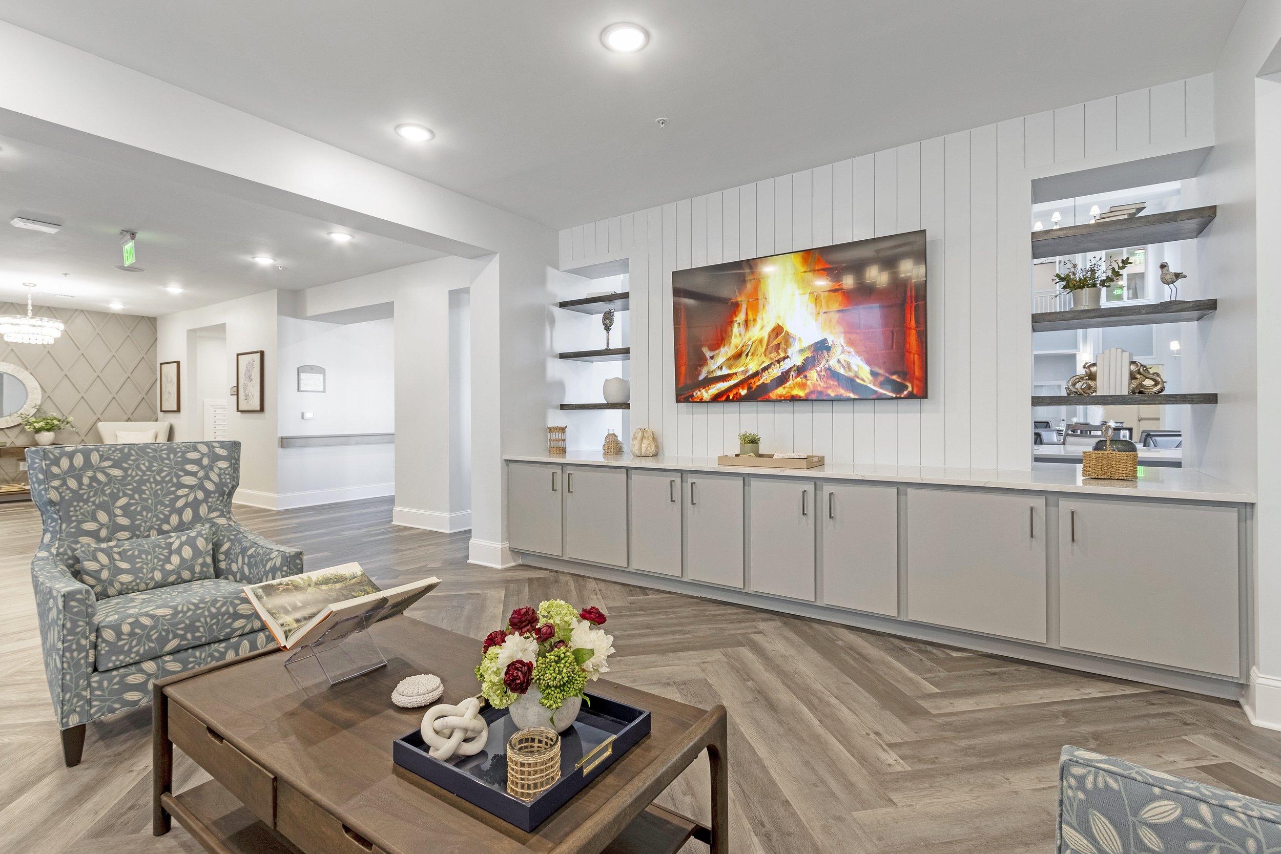 Micamy Design Studio_Canopy at Beacon Woods_Entertainment Wall_Herringbone Floor_Floating Shelves_Patterned Chairs_Coffee Table Decor (2).JPG