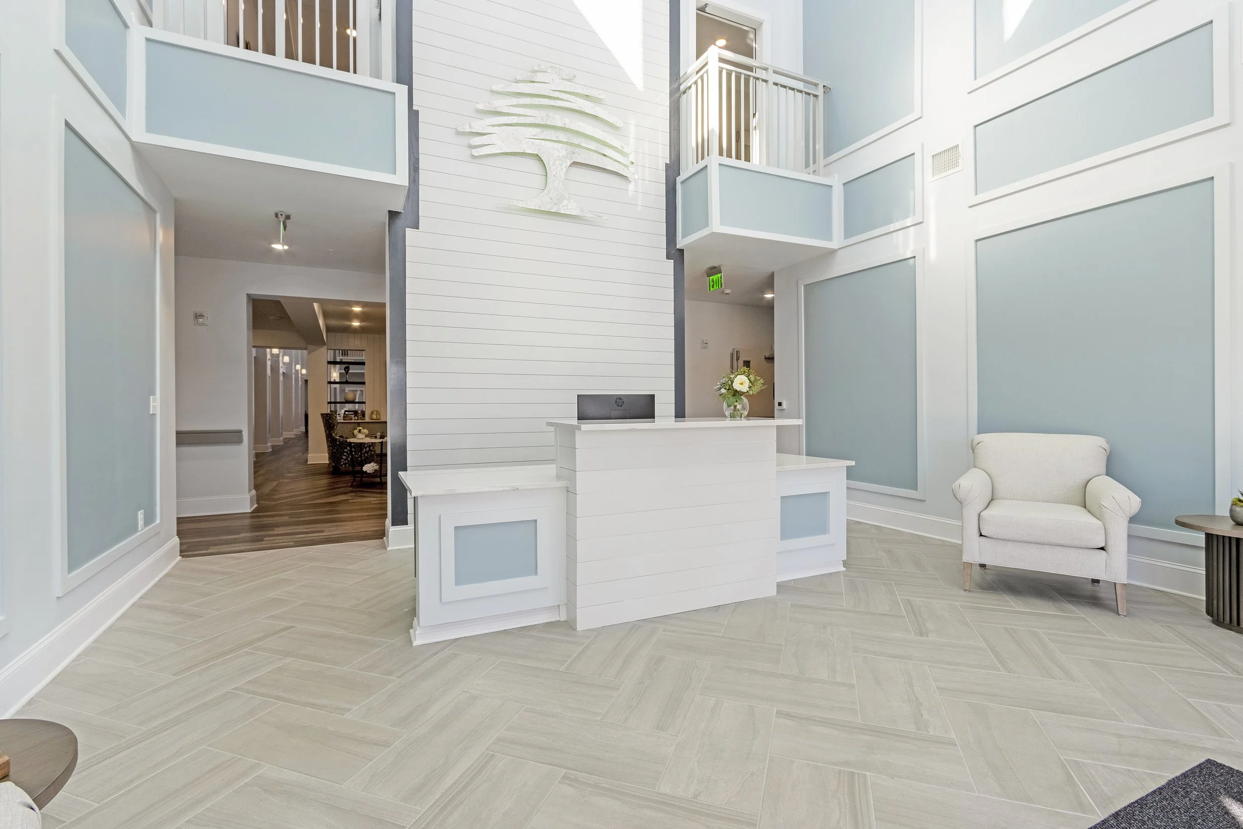 Micamy Design Studio_Canopy at Beacon Woods_Lobby_Herringbone Tile_Guest Chair_Logo Accent Wall_Blue Paint_White Decorative Wall Trim_ADA Accessible Desk_Balcony.JPG