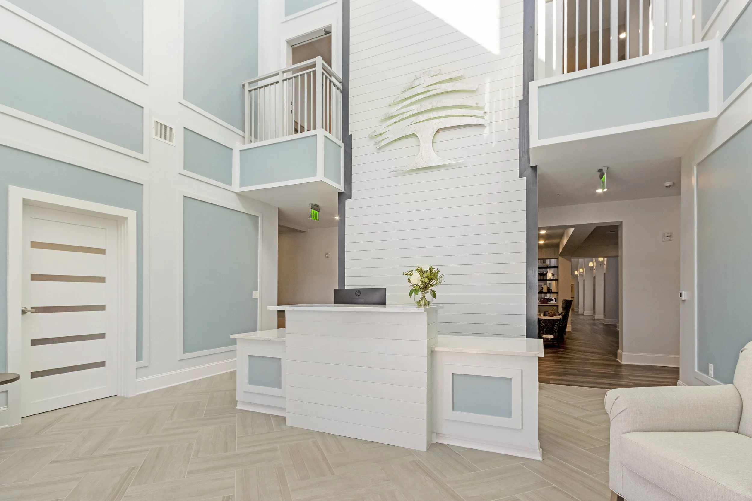 Micamy Design Studio_Canopy at Beacon Woods_Lobby_Herringbone Tile_Two Story_Logo Accent Wall_Blue Paint_White Decorative Wall Trim_ADA Accessible Desk_Balcony.JPG