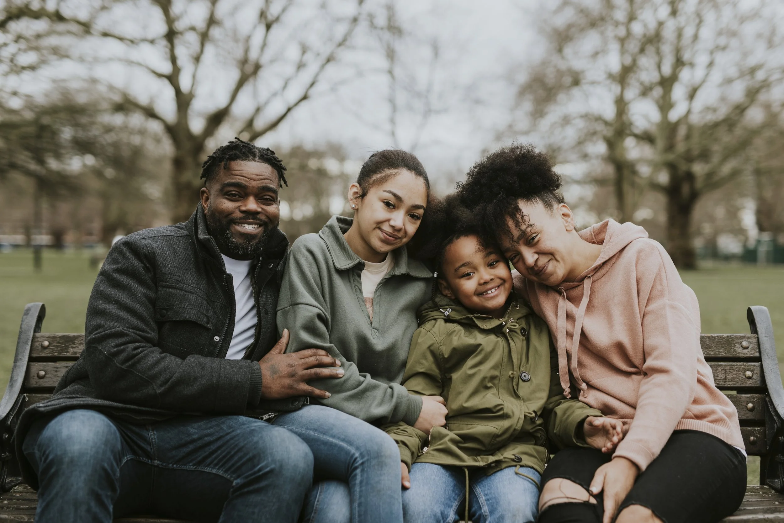 Black family sitting on park bench.jpg
