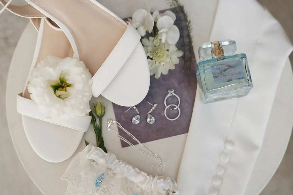 bride's shoes with the flowers and rings and her gloves and garter
