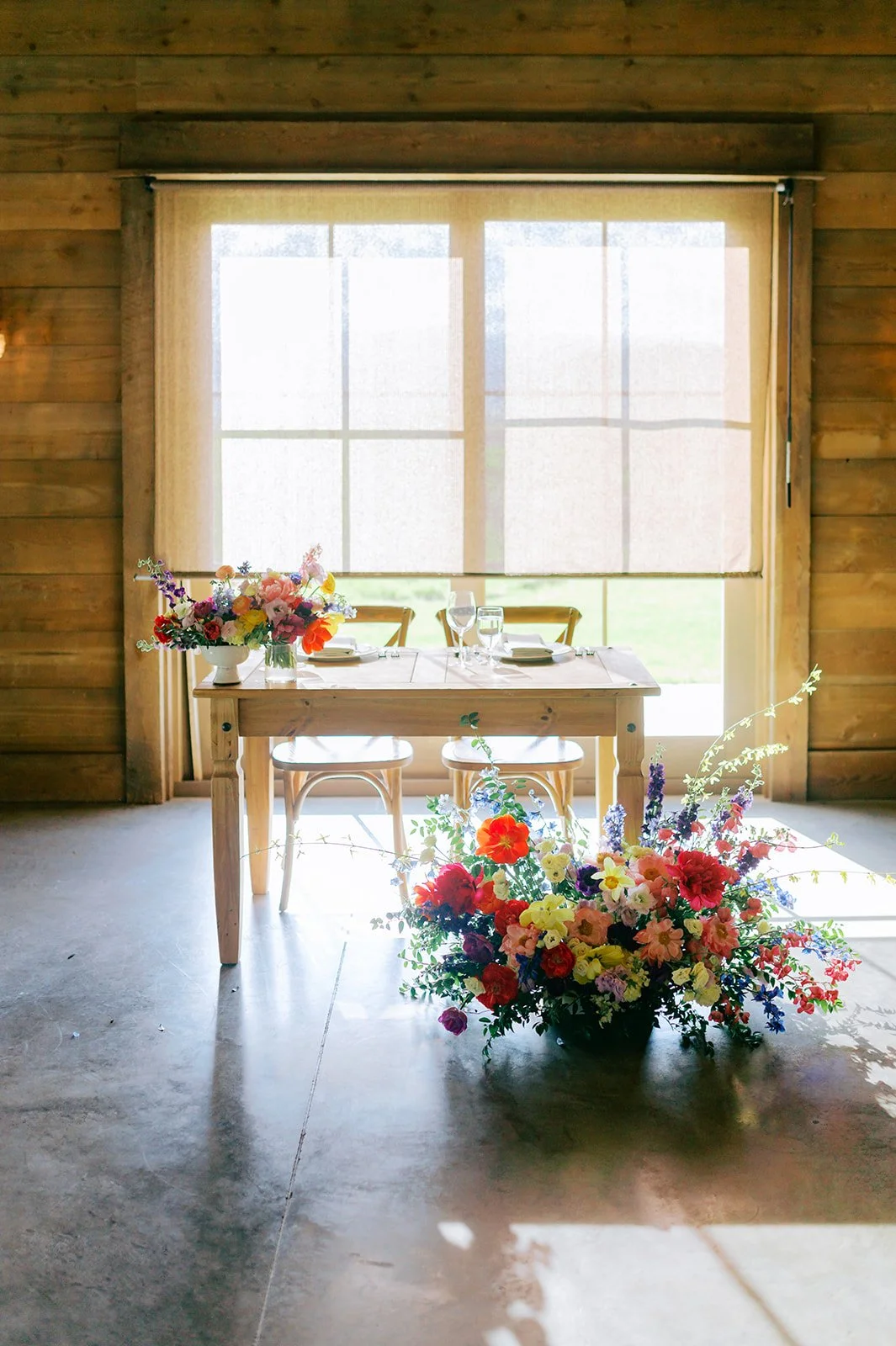 Sweetheart table with ceremony arrangement repurposed in front