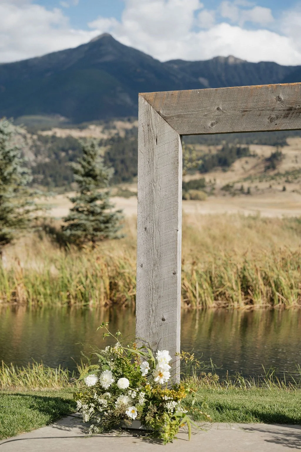 the arch at copper rose ranch with a simple floral arrangement at the base of the left side of the arch 