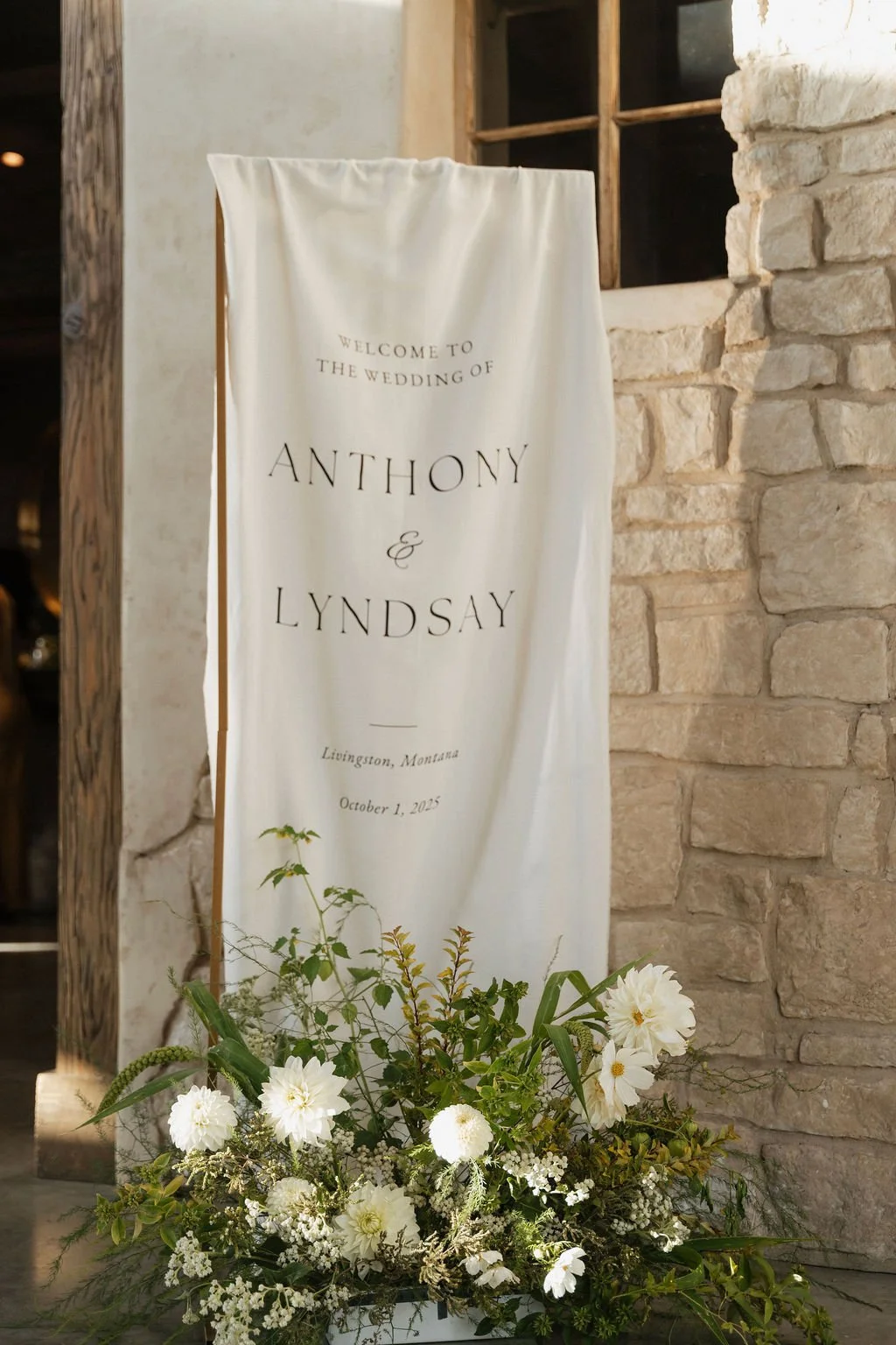 one of the ceremony arrangements at the foot of the cloth welcome sign 
