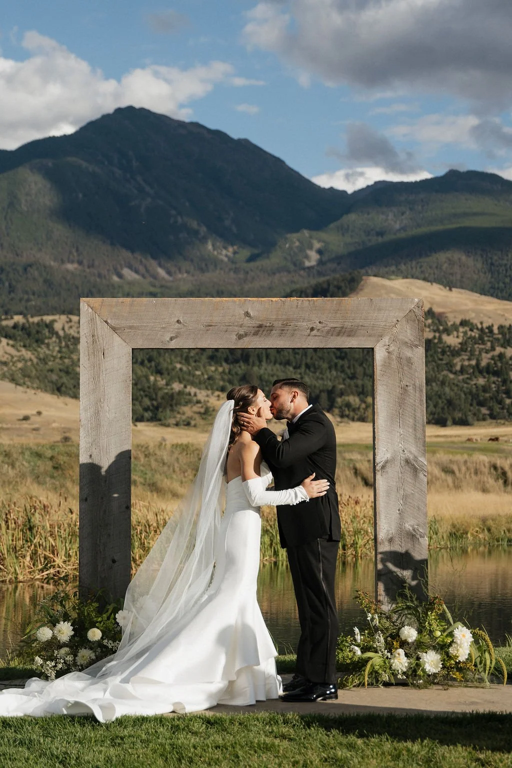 the first kiss with the arch and mountains behind