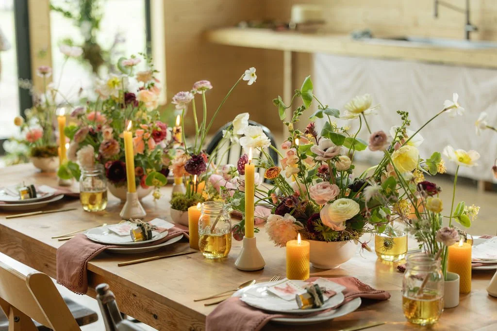bozeman montana florists arrangements using with beeswax candles with flowing, whimsical florals on a rustic table