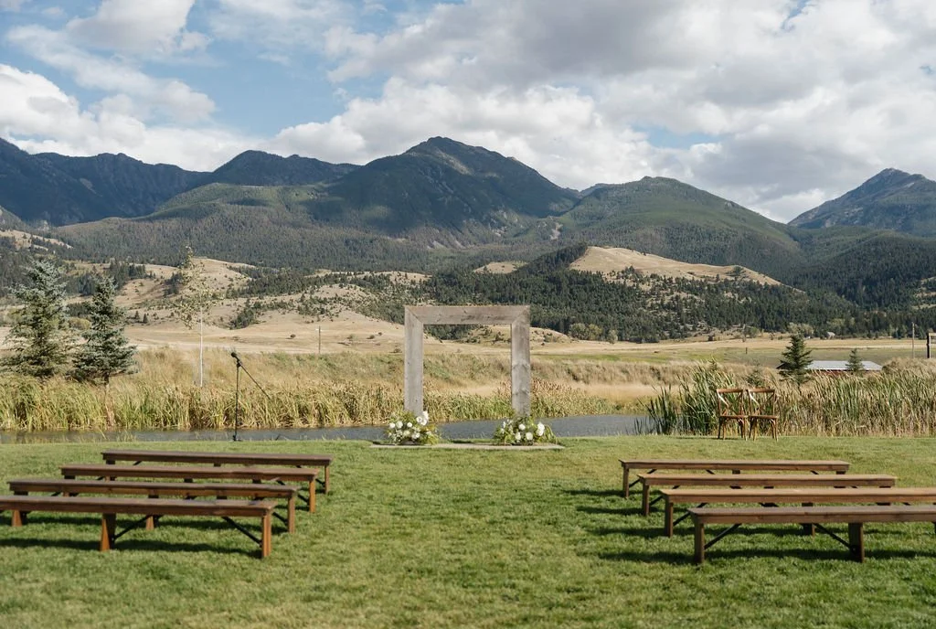 a wide angle shot of the benches and arch at copper rose ranch with emigrant peak behind