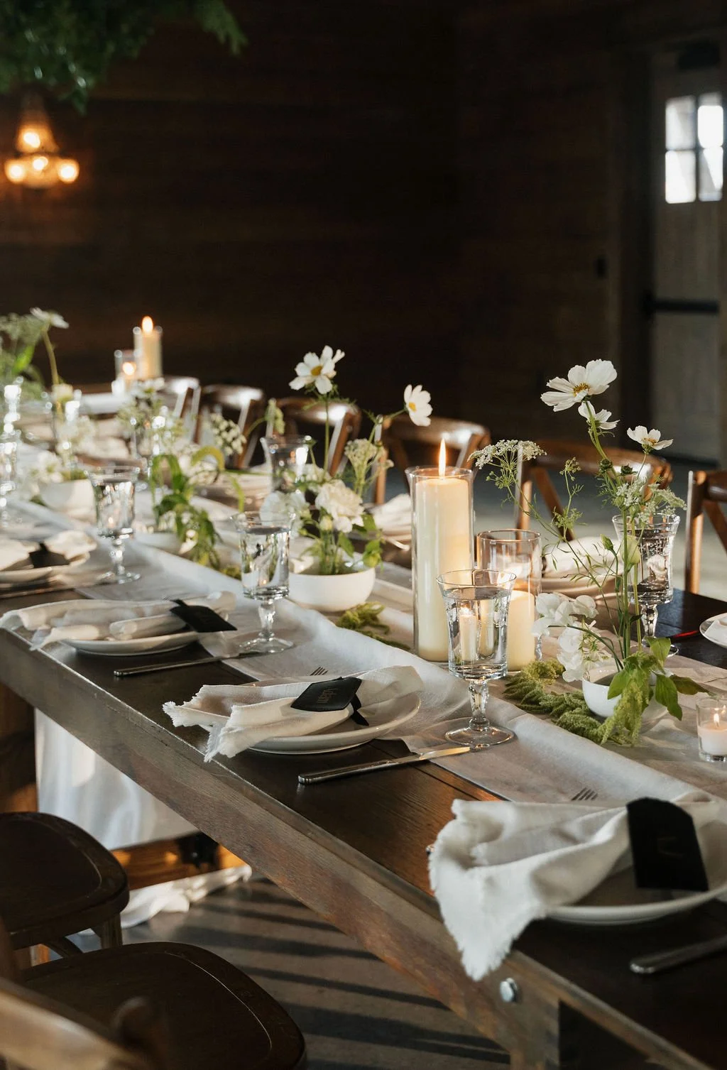 the ikebana table settings with the candles lit