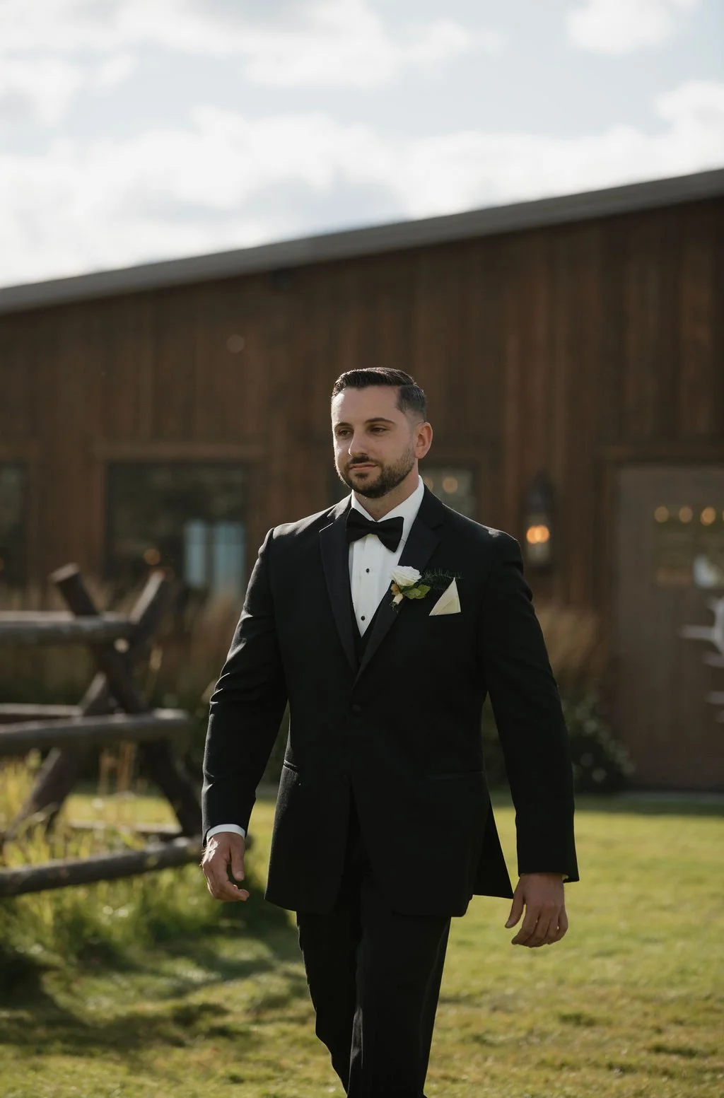 the groom walking down the aisle with his boutonniere