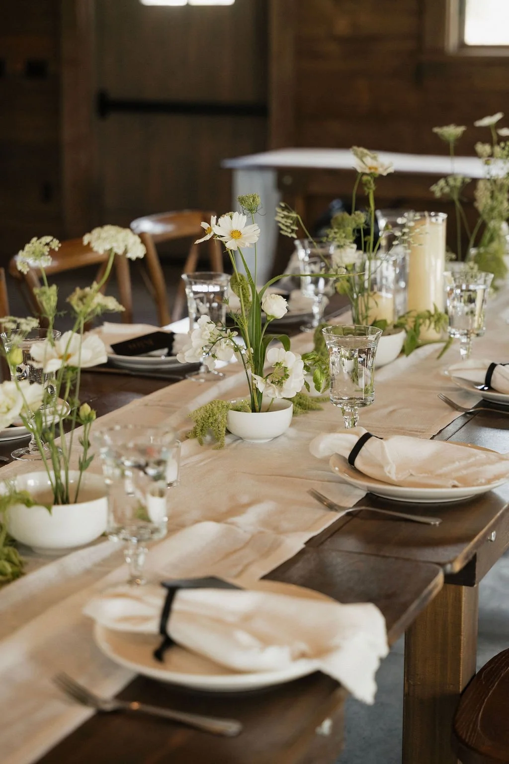 a detail shot of the ikebana arrangements on the white linen