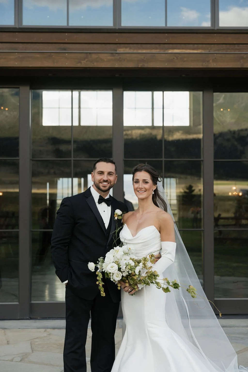 portrait of the bride and groom together outside of the barn at copper rose ranch