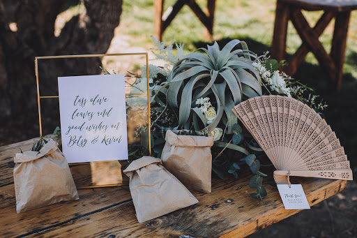 welcome table sign and olive confetti and fan.jpg
