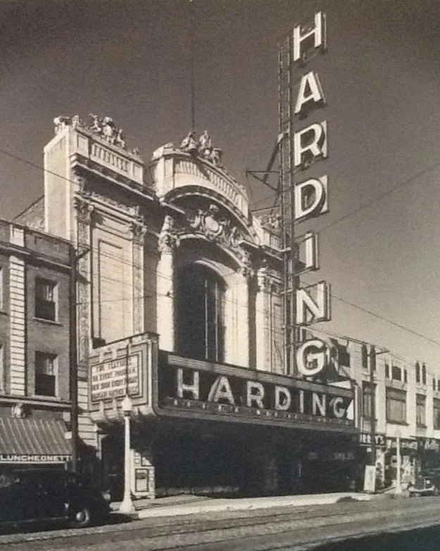 Historical black and white photo of the Harding Theater marquee with vertical signs spelling 'HARDING' on top of the building facade.