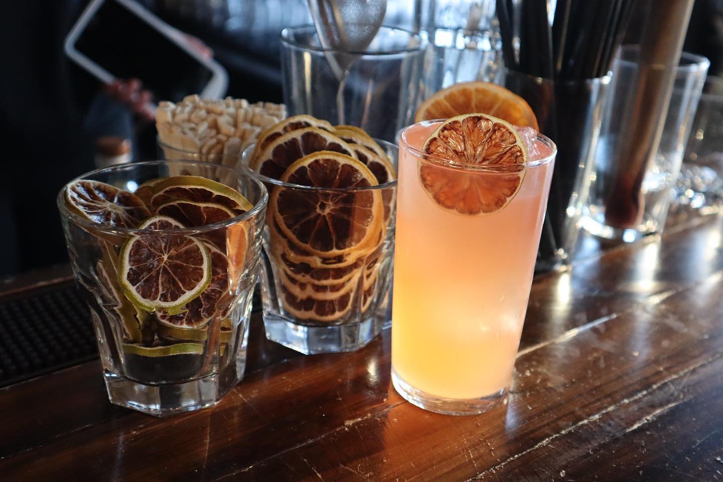 Candied oranges are used to garnish a craft cocktail at Timekeeper Distillery.