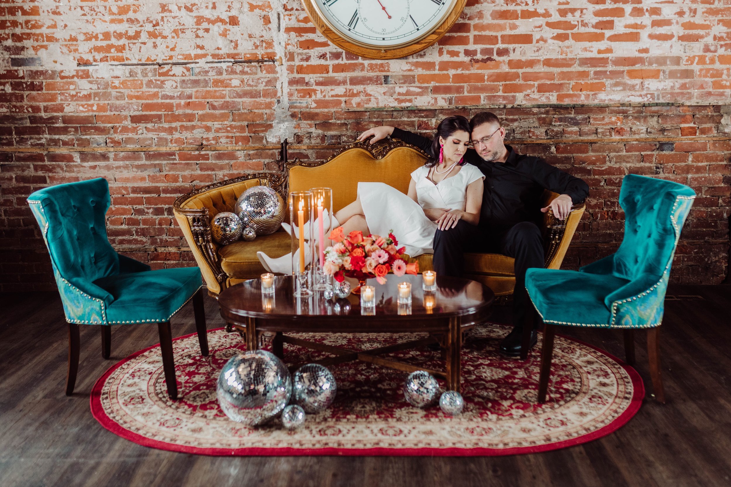 Bride and groom romatically lounge on a settee at Timekeeper Distillery.