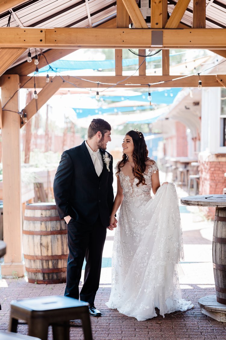 Bride and groom look into each others eyes on the outdoor patio at Timekeeper Wausau Historic Depot.