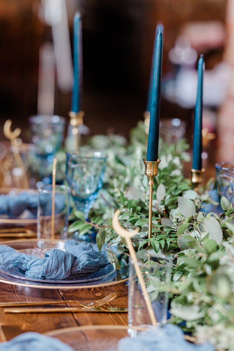A Timekeeper banquet table is decorated in navy and gold for a wedding.