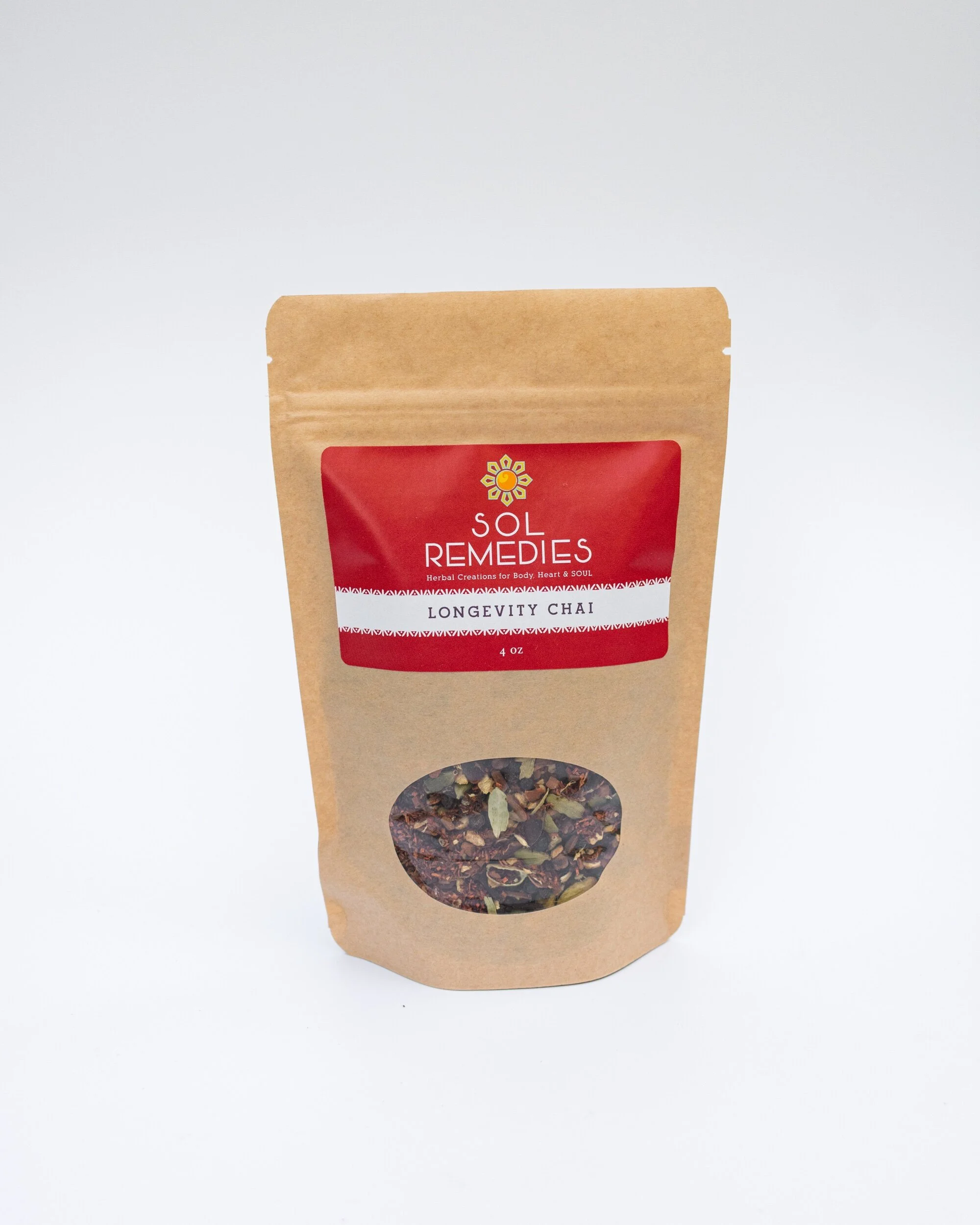 Tan and Red pouch of Longevity Chai Tea with clear window on package