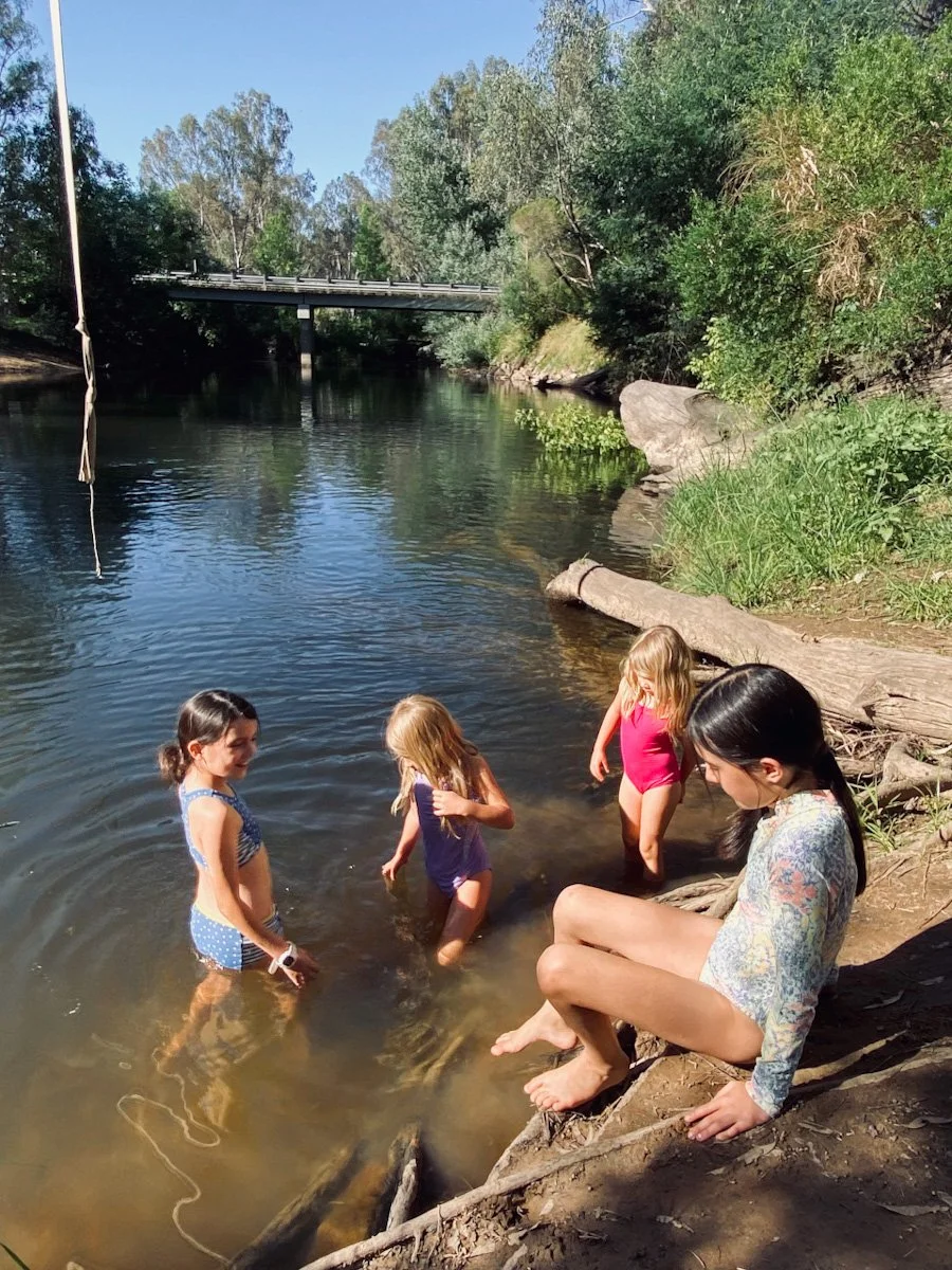 Children swimming in the river during summer in North East Victoria