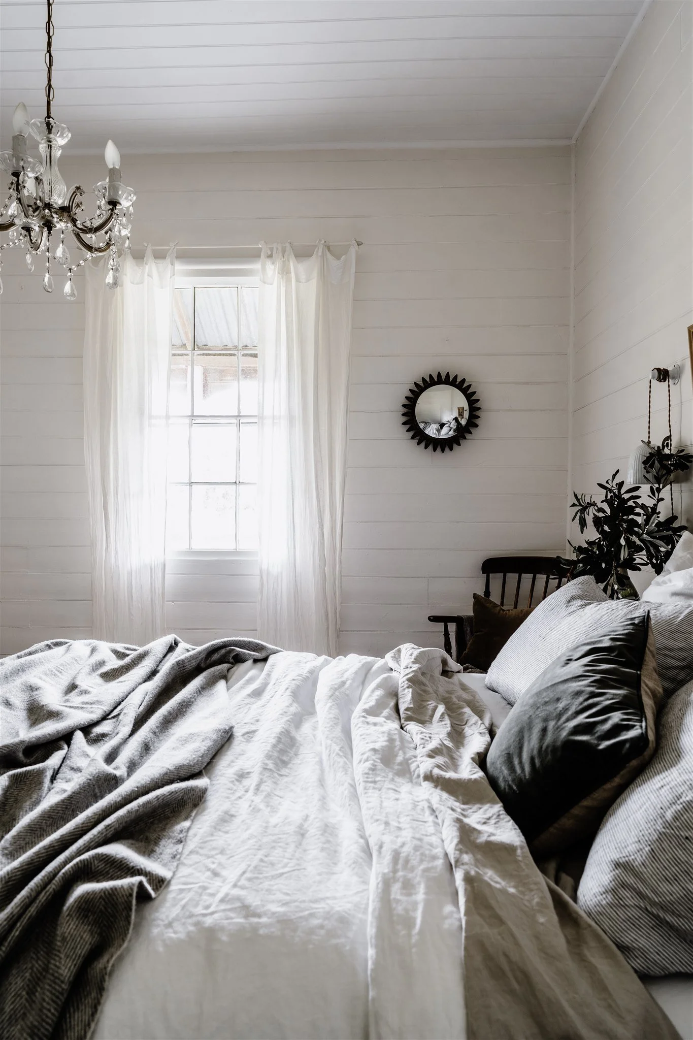 Light-filled cottage bedroom at Dunmore Farm in North East Victoria with linen bedding and soft morning light