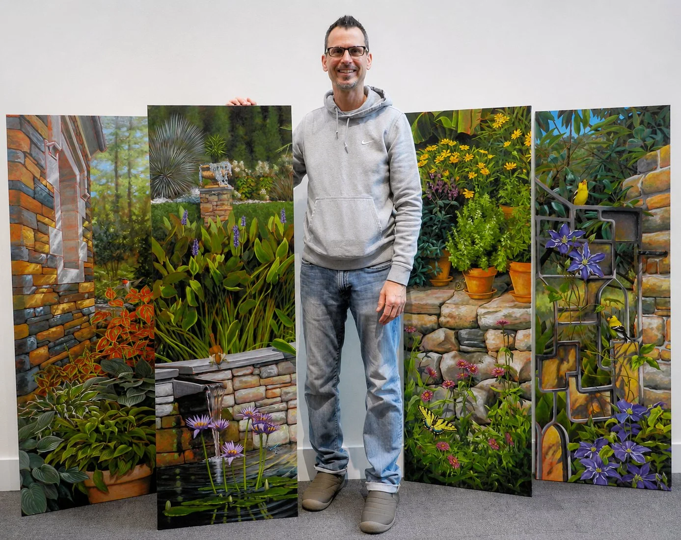 Artist Matt Tomko with paintings commissioned by Duke University for its permanent collection.