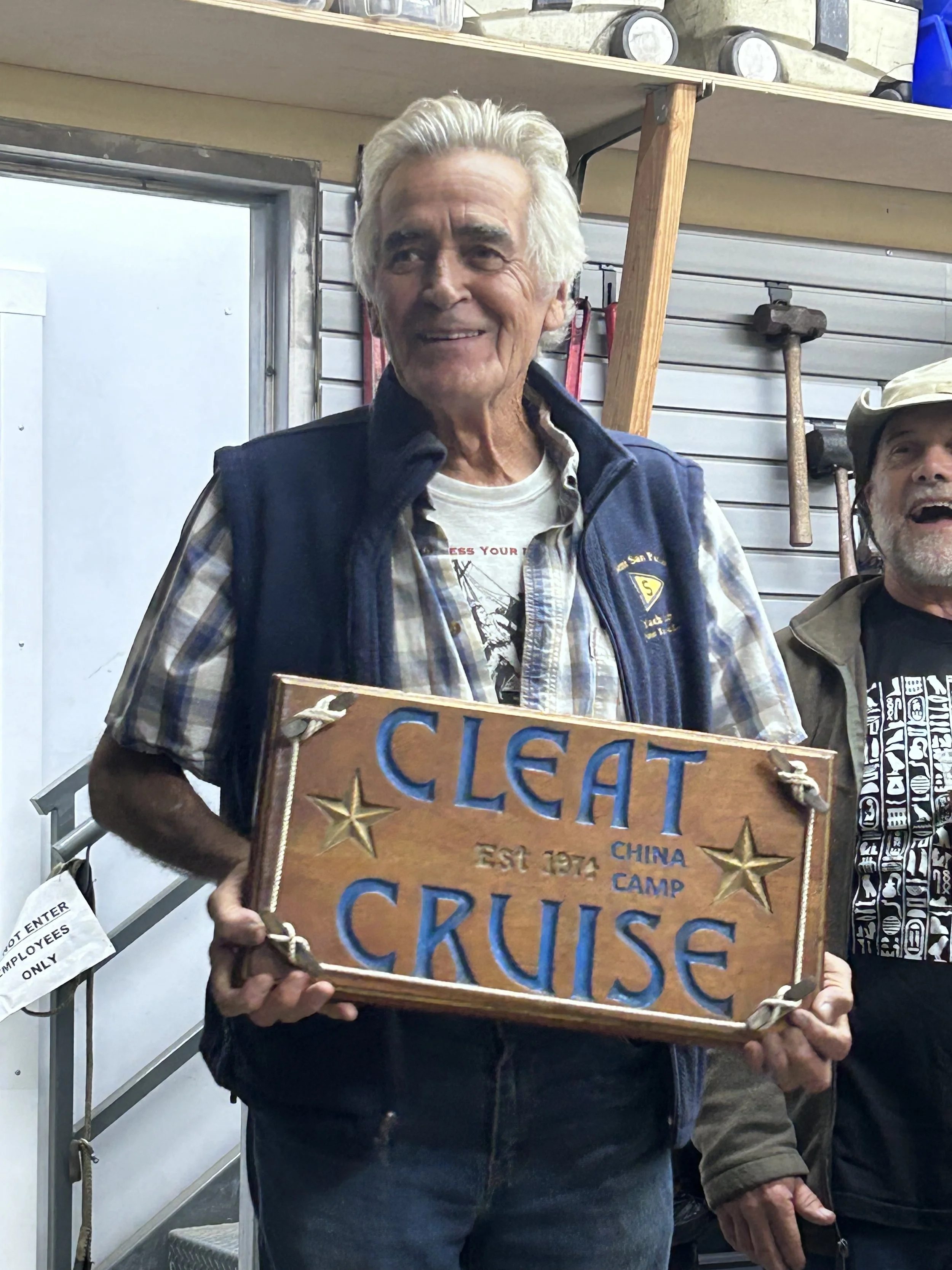 Louis Nickles holding the Cleat Cruise trophy at List Marine.